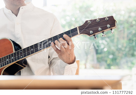 Hand of a man playing the guitar Hand of a man playing the guitar 131777292