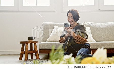 Woman operating a mobile phone Woman operating a mobile phone 131777436