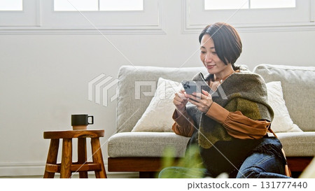 Woman operating a mobile phone 131777440