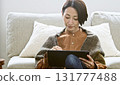 Woman operating a tablet 131777488