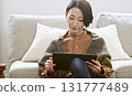 Woman operating a tablet 131777489