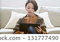 Woman operating a tablet 131777490