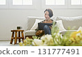 Woman operating a tablet 131777491