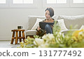 Woman operating a tablet 131777492
