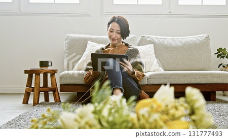 Woman operating a tablet Woman operating a tablet 131777493