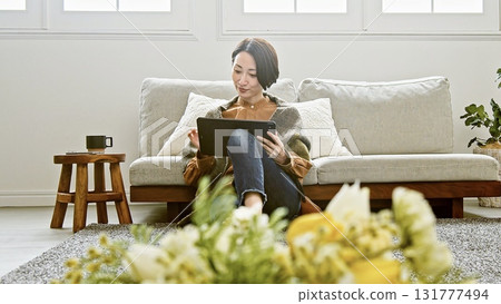 Woman operating a tablet Woman operating a tablet 131777494