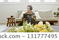 Woman operating a tablet 131777495