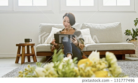 Woman operating a tablet 131777496