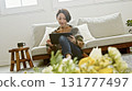 Woman operating a tablet 131777497