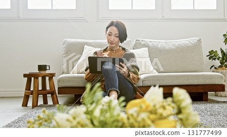 Woman operating a tablet Woman operating a tablet 131777499