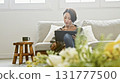 Woman operating a tablet 131777500