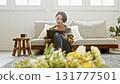 Woman operating a tablet 131777501