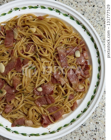 Classic spaghetti coated in rich tomato sauce, offering a simple yet delicious combination of tangy, savory flavors perfect for a comforting meal. 131777529