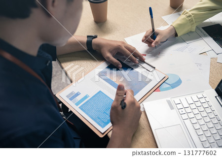 Business people, hands-on work, and people with documents in the office for data analysis, company reports, or performance reviews. Financial analysts, teams, and documents for financial forecasting,  131777602