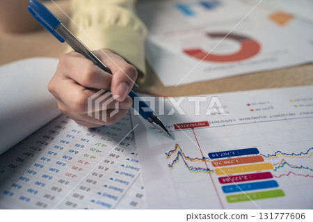 Business people, hands-on work, and people with documents in the office for data analysis, company reports, or performance reviews. Financial analysts, teams, and documents for financial forecasting,  131777606