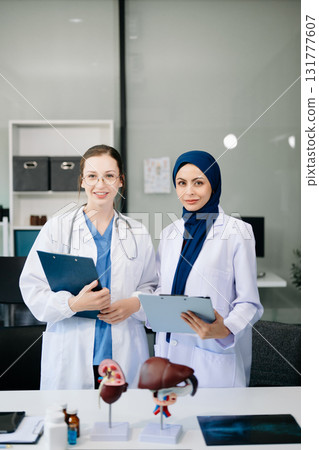 Successful team of medical doctors looking at camera and smiling while standin. Health, professional and people team in hospital Successful team of medical doctors looking at camera and smiling while standin. Health, professional and people team in hospital 131777607
