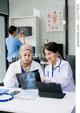 Medical technology network team meeting concept. Doctor hand working with smart phone modern digital tablet and laptop computer with graphics chart in hospital Medical technology network team meeting concept. Doctor hand working with smart phone modern digital tablet and laptop computer with graphics chart in hospital 131777675