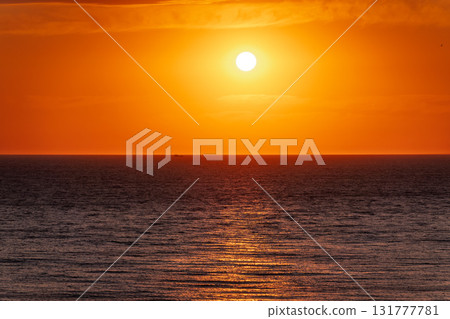 Beautiful red and orange sunrise over the sea. Beautiful red and orange sunrise over the sea. 131777781