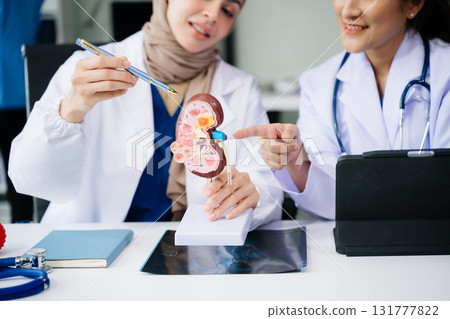 Medical technology network team meeting concept. Doctor hand working with smart phone modern digital tablet and laptop computer with graphics chart in hospital Medical technology network team meeting concept. Doctor hand working with smart phone modern digital tablet and laptop computer with graphics chart in hospital 131777822