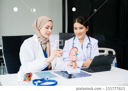 Doctors analyzing results or diagnosis of patient in clinic. Teamwork, medical and healthcare workers in discussion and research on desk in hospital Doctors analyzing results or diagnosis of patient in clinic. Teamwork, medical and healthcare workers in discussion and research on desk in hospital 131777823