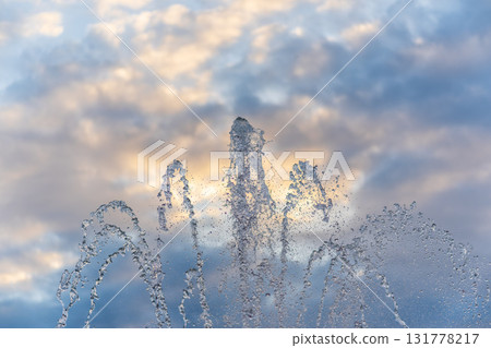 Splashes and jets of water against light background. 131778217