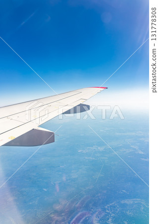 View from the airplane window at a beautiful blue clear sky and the airplane wing 131778308