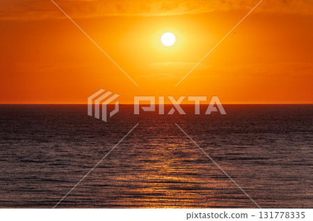 Beautiful red and orange sunrise over the sea. Beautiful red and orange sunrise over the sea. 131778335
