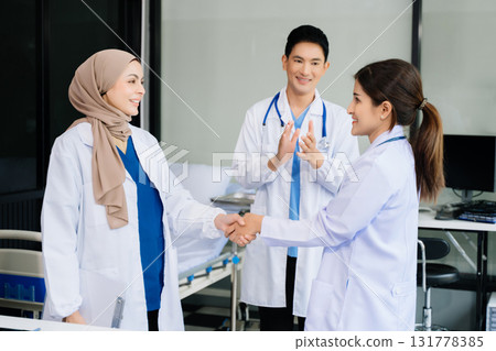 Doctor handshake and partnership in healthcare, medicine or trust for collaboration, unity or support.Team of medical experts shaking hands Doctor handshake and partnership in healthcare, medicine or trust for collaboration, unity or support.Team of medical experts shaking hands 131778385