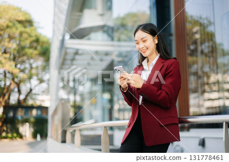 oung Asian business woman leader entrepreneur, professional manager holding digital tablet computer 131778461