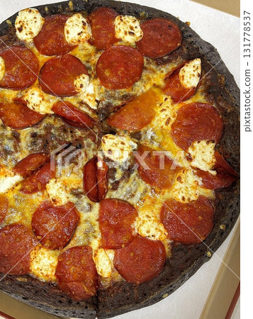 A delicious pizza with a golden crust, melted cheese, and savory toppings. Perfect for food-related designs, menus, or Italian-themed projects, capturing the essence of a classic comfort dish. 131778537