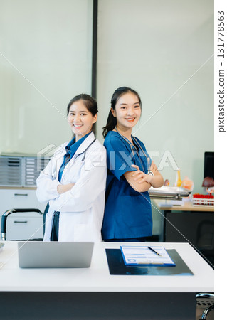 Healthcare professionals analyzing test results with lab tools, stethoscopes in a clinical setting. Showcase teamwork 131778563