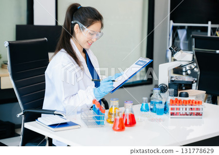 Scientists, beakers, and microscopes in cutting-edge research. Perfect for science and technology projects. 131778629