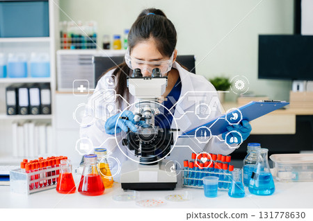 DNA molecule testing concepts. The doctor in a mask examines DNA molecules on the chemical laboratory DNA molecule testing concepts. The doctor in a mask examines DNA molecules on the chemical laboratory 131778630