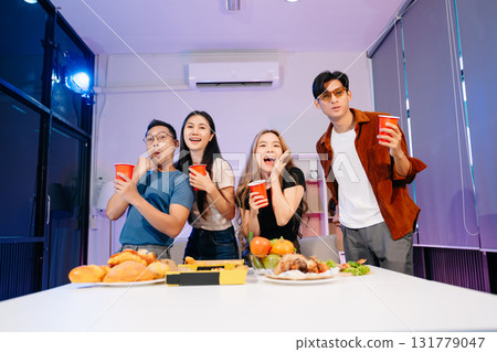 Celebration with friends enjoying food, drinks, and laughter at a lively house party. Perfect for themes of joy 131779047