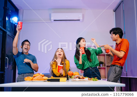 Celebration with friends enjoying food, drinks, and laughter at a lively house party. Perfect for themes of joy Celebration with friends enjoying food, drinks, and laughter at a lively house party. Perfect for themes of joy 131779066