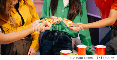 Celebration with friends enjoying food, drinks, and laughter at a lively house party. Perfect for themes of joy Celebration with friends enjoying food, drinks, and laughter at a lively house party. Perfect for themes of joy 131779076