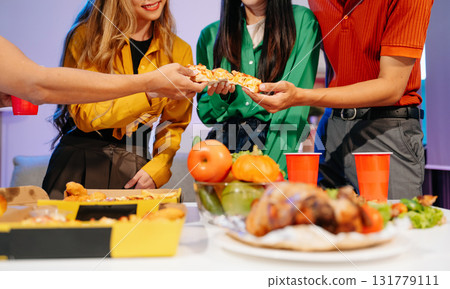 Celebration with friends enjoying food, drinks, and laughter at a lively house party. Perfect for themes of joy 131779111