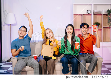 Celebration with friends enjoying food, drinks, and laughter at a lively house party. Perfect for themes of joy Celebration with friends enjoying food, drinks, and laughter at a lively house party. Perfect for themes of joy 131779234