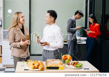 Lively office party with coworkers celebrating, enjoying pizza and drinks, and fostering team spirit 131779258