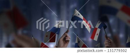 Panama flags in their hands on a blurred urban background Panama flags in their hands on a blurred urban background 131779302