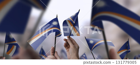 Marshall flags in their hands on a blurred urban background Marshall flags in their hands on a blurred urban background 131779305