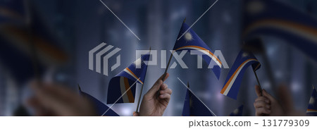 Marshall flags in their hands on a blurred urban background Marshall flags in their hands on a blurred urban background 131779309