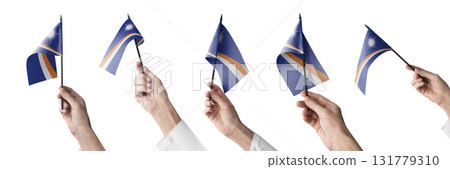The Marshall flag in hand in different angles on a white background 131779310