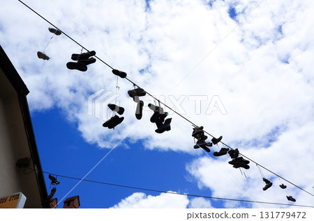A pile of shoes hanging out to dry on a street in Croatia 131779472