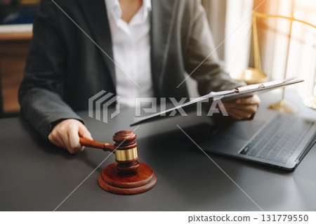 justice and law concept.Male judge in a courtroom on wooden table and Counselor or Male lawyer working 131779550