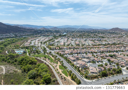 Aerial view of a sprawling neighborhood of family homes in Menifee, California, USA. Aerial view of a sprawling neighborhood of family homes in Menifee, California, USA. 131779663