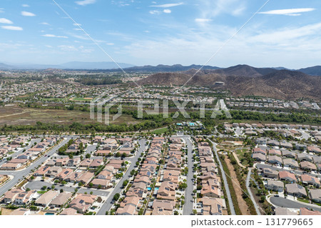 Aerial view of a sprawling neighborhood of family homes in Menifee, California, USA. Aerial view of a sprawling neighborhood of family homes in Menifee, California, USA. 131779665