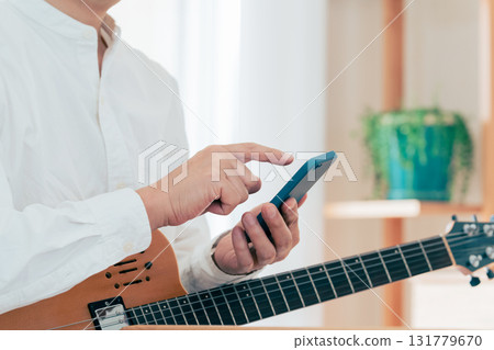 Hand of a man playing the guitar 131779670