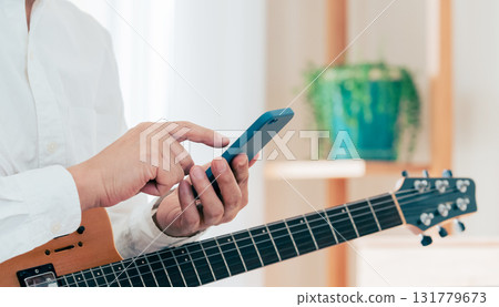 Hand of a man playing the guitar 131779673