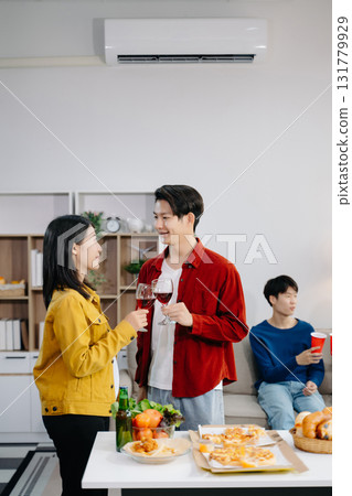 Group of Young Asian friend having, enjoy evening party together at home. Attractive young man and woman having fun, eating food, celebrate at home 131779929